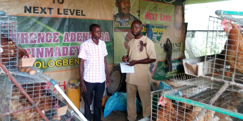 IITA-CARE researcher, Bello, with a respondent during field survey.