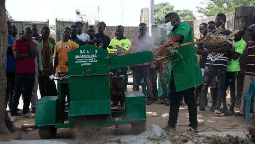 Activity staff, trains participants to use the Stover Crusher.