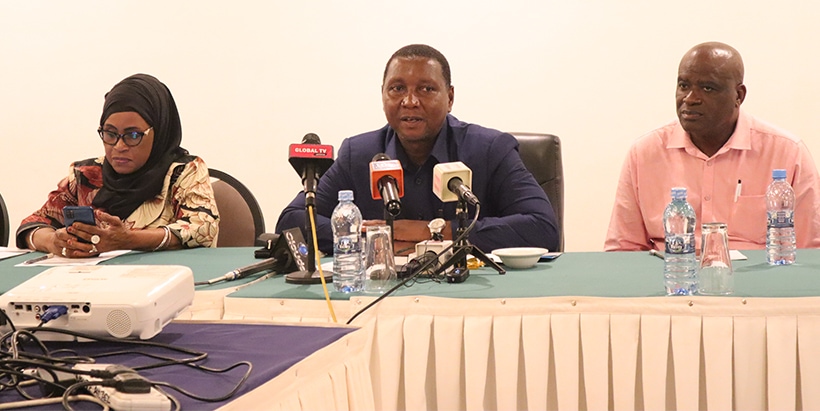 Minister of Agriculture, Hon prof Adolf Mkendi (centre), addressing the meeting participants. He is flanked by the Chairperson of Tanzania Cassava Producers and Processors Association (TACAPPA) Ms Mwantumu Mahiza (right) and MP, Handeni Rural, Hon. John Michael Sallu (left).