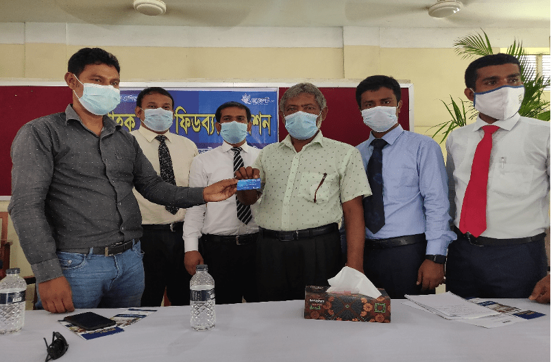 A farmer from Gaibandha receives a Fish Card as part of obtaining a loan from Bank Asia. Photo by Debasish Bhattacharjee:WorldFish