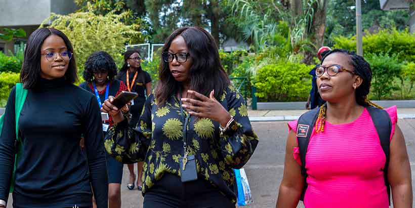 APDC trainees, Adannaya Okpara (left) and Amaka Chime (right) learning about HOTRAS activities with Resident Manager Bridget Mangulama (center).