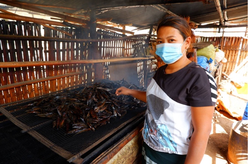 Win Chewa Htun produces smoked fish for a living together with her husband. Photo by Kyaw Moe Oo.