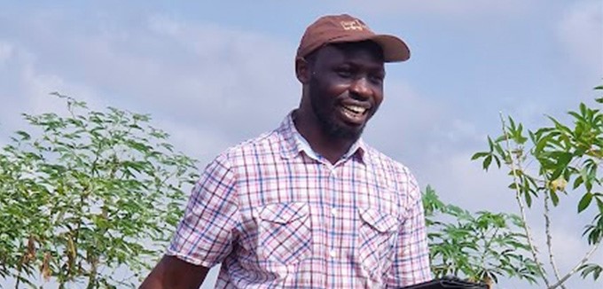 IITA researcher Siraj Ismail Kayondo at cassava trial plot during harvest.