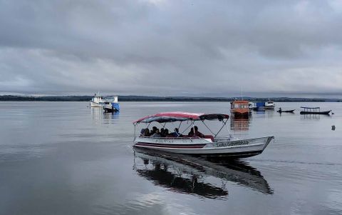A boat transports passengers near a fishing community on the Tapajós River in Brazil