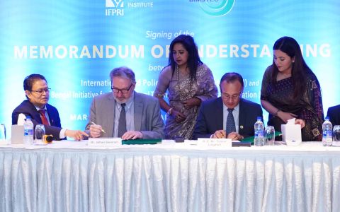 Johan Swinnen of IFPRI and Tenzin Lepkelle of BIMSTEC (center, seated) sign the Memorandum of Understanding between the two organizations. Shahidur Rashid of IFPRI is at left.