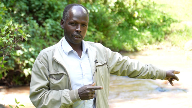 Richard Kamng’oror, CEO of Endorois Welfare Council, showing the extent of browning of fresh water in an Eldama Ravine river, Baringo County (Photo credit: Samwel Getui Basigwa)