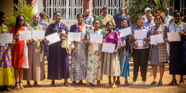 Agri-multiplier structures led by women, brandishing their certificate of participation.