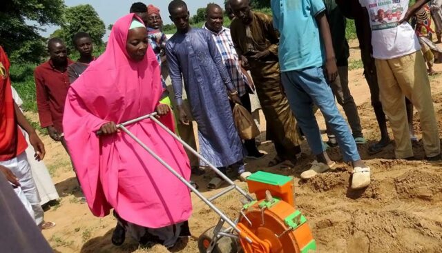 Female-farmer-in-Albasu-practicing-how-to-sow-seeds-using-the-planter.