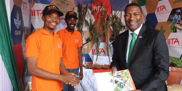 McDonald Nundwe, presenting the Minister, Hon Sam Kawale with a knowledge-sharing package for his reading.