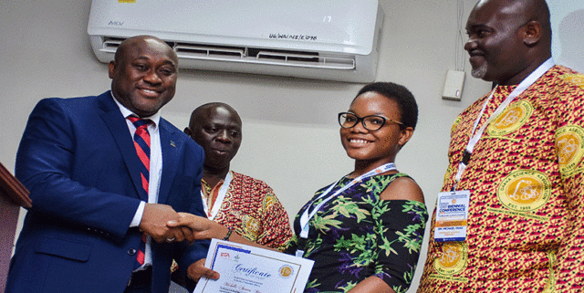 Young scientist winner Michelle Atawa Mensah receiving her award.