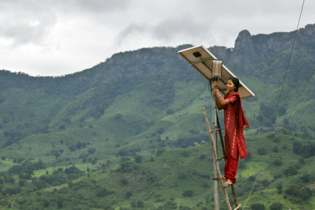 Meenakshi Dewan tends to maintenance work on the solar street lighting in her village of Tinginaput, India. Photo: Abbie Trayler-Smith / Panos Pictures/USAID.
