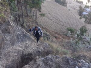 An enumerator climbs a steep hill to reach survey respondents in Ethiopia. (Photo credit: ILRI/Tigist Worku). 