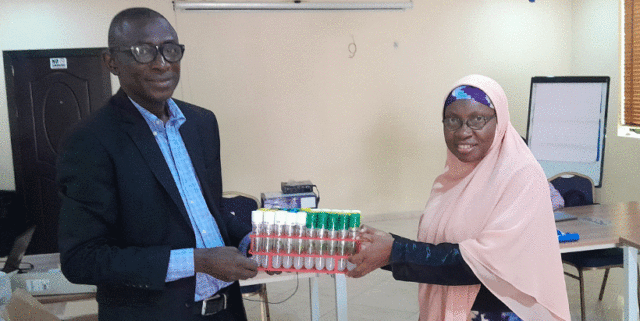 Prof Morufat Balogun received untested seed yam from Dr David Apriah-Kubi from CSIR-CRI.