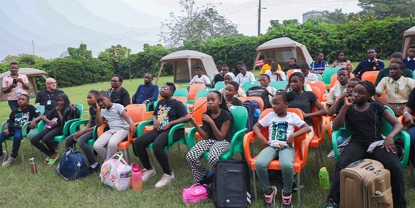 Students with their camp bags receiving camp rules on arrival for the Nigerian Bird Festival 2023 celebration.