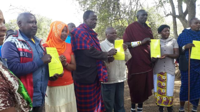 ALOLLE participatory land use management (PLUM) members holding their joint village land use plan. Credit: KINNAPA/ILRI.