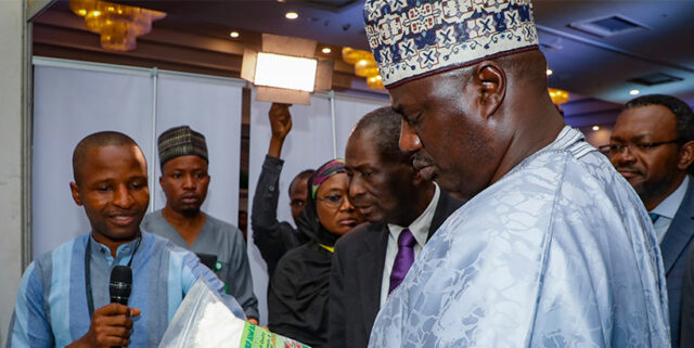 Minister of State for Agriculture, Sen. Aliyu Sabi Abdullahi examining products at the Exhibition.