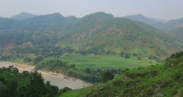 Landscape with river, agricultural fields and mountains