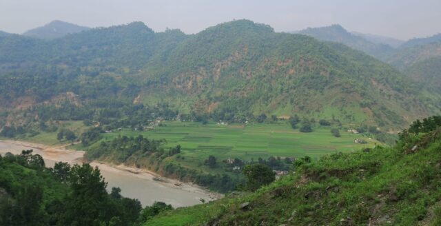 Photo showing landscape with hills and river.