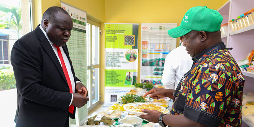 Peter Iluebbey, IITA Cassava Breeding International Trials Manager, sharing the existing opportunities in cassava value chain with Ambassador Christophe Bazivamo.