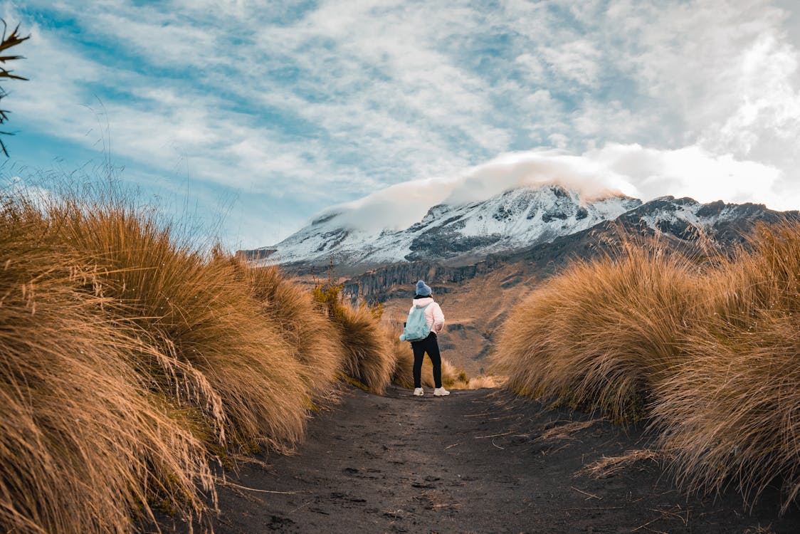 free-photo-of-woman-standing-on-footpath-with-mountain-behind.jpeg