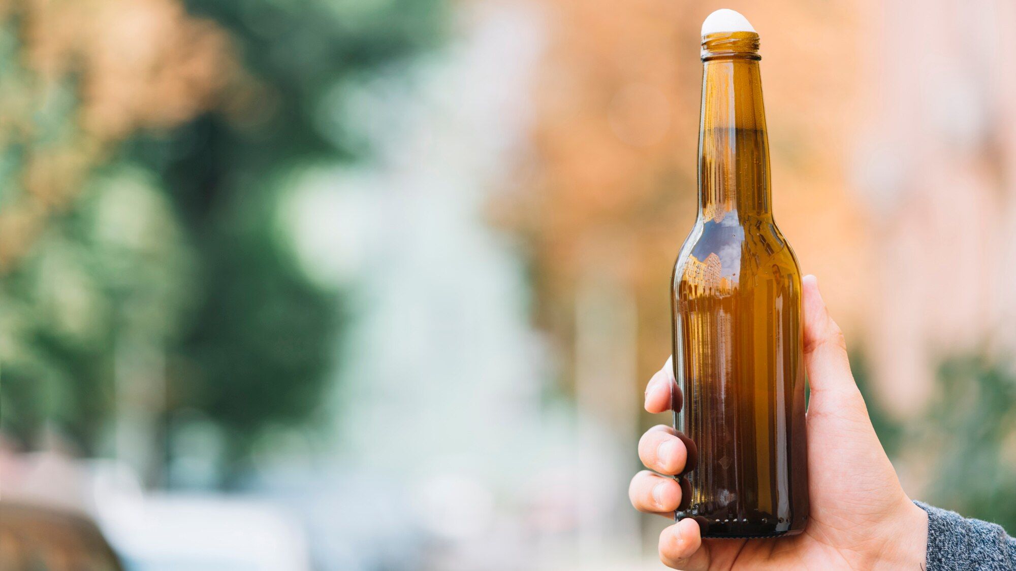 human-hand-holding-beer-bottle_23-2147919802.jpg