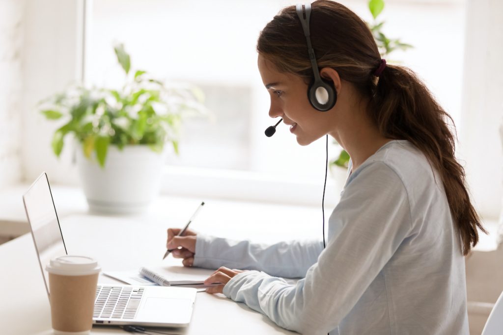 Smiling receptionist talking to customers via Chat Software