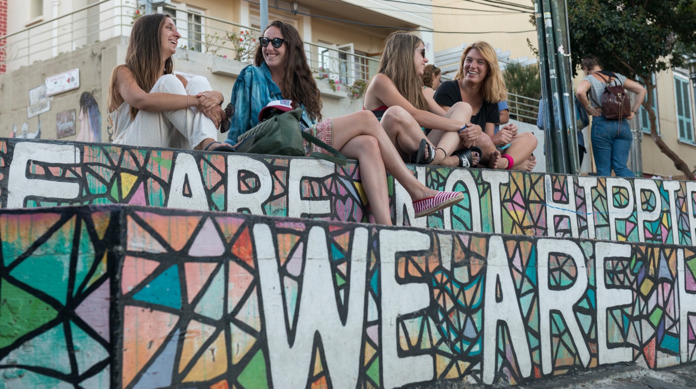 Imagen que muestra un graffiti en las escaleras de Valpraiso con un grupo de mujeres turistas retratándose en ella