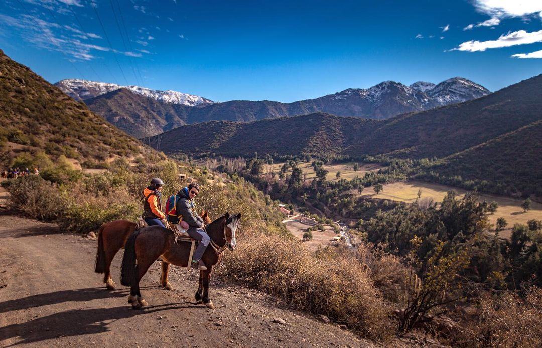 People on horseback contemplating the Farellones landscape