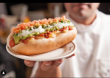 Chef showing a completo on a plate