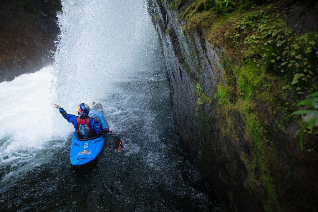 Aniol Serrasolses paddling under a waterfall