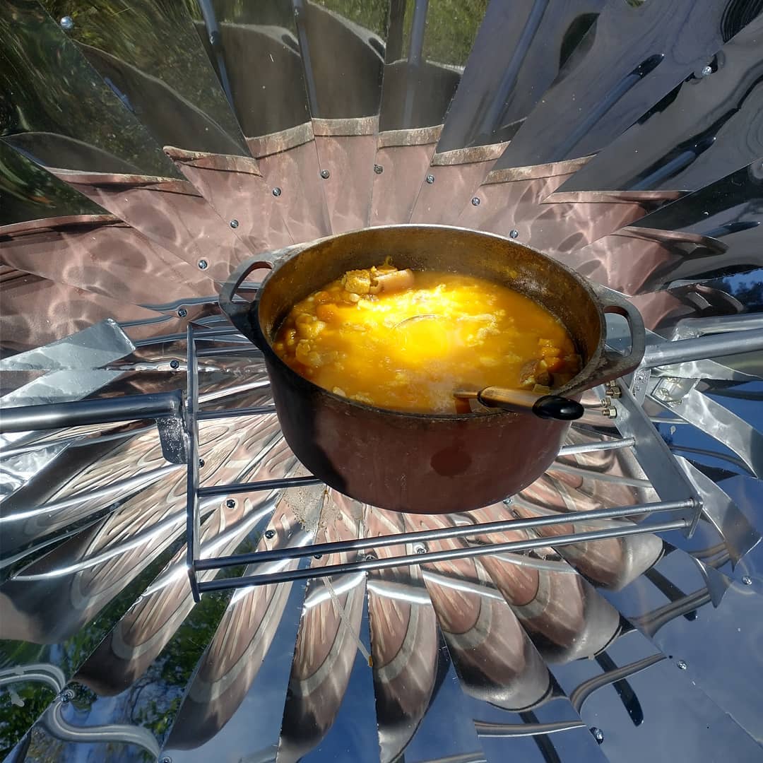 Pot of soup cooking on a solar stove 