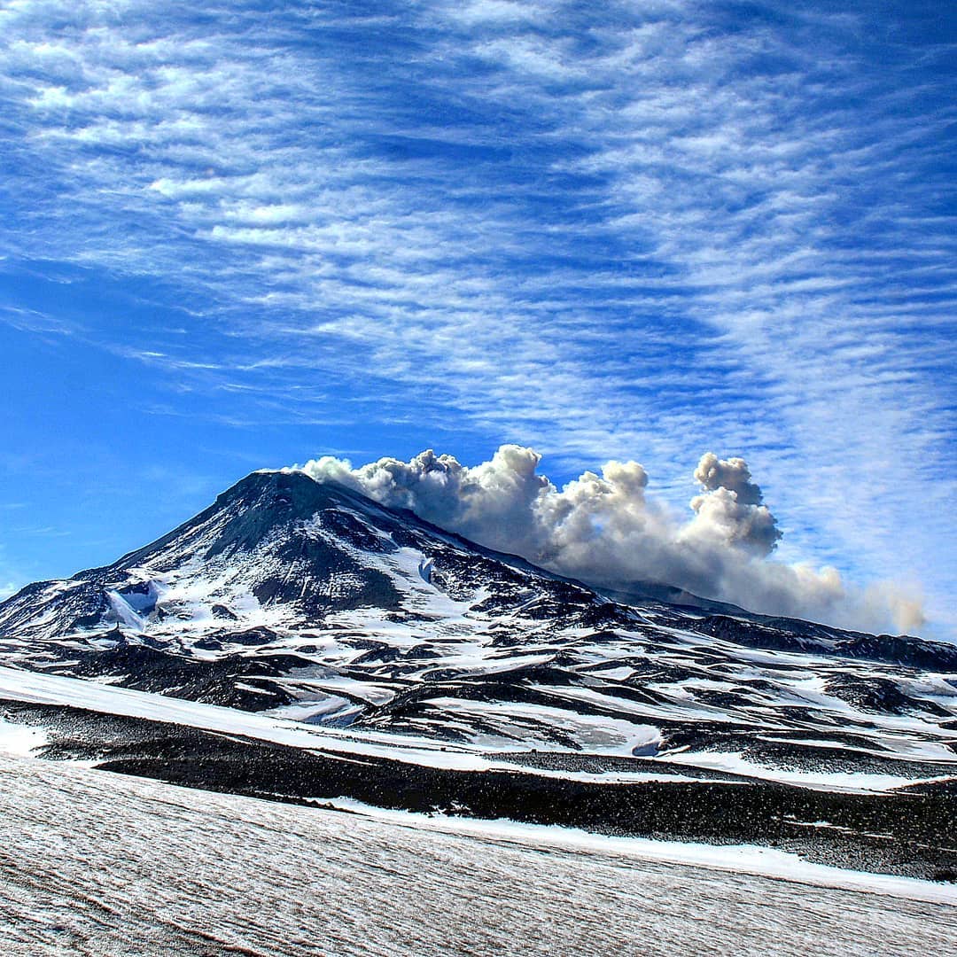 Snow-capped Chillán volcano with fumarole