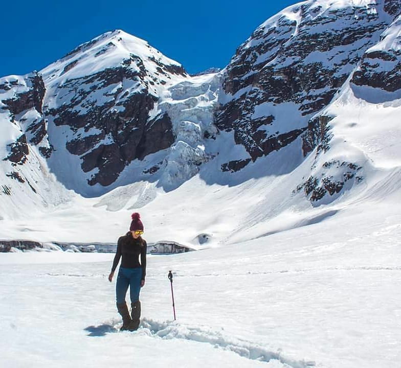 Woman at the base of the Colgante del Morado glacier, Cajón del Maipo, Chile