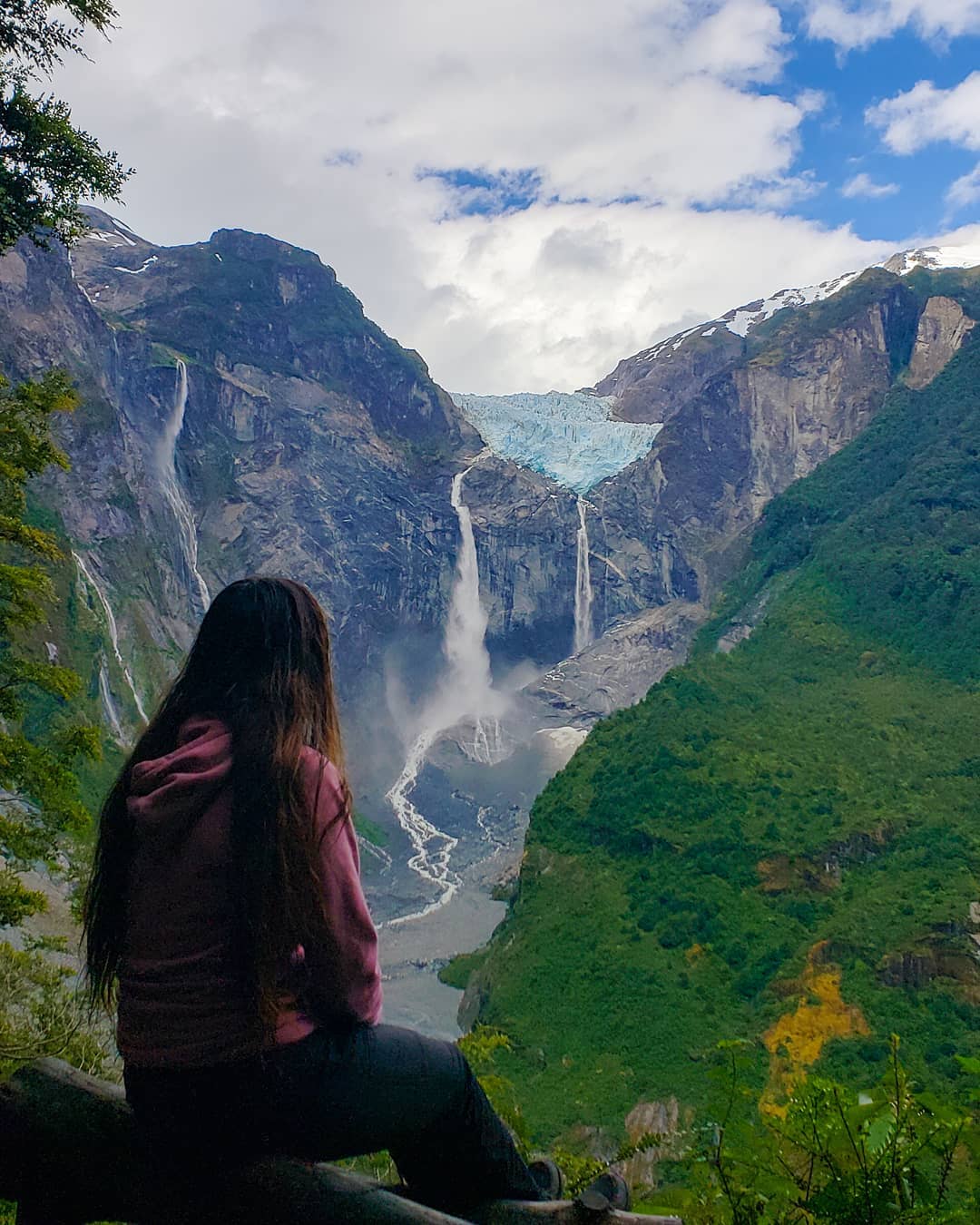 Woman contemplating El Colgante hanging glacier, southern Chile