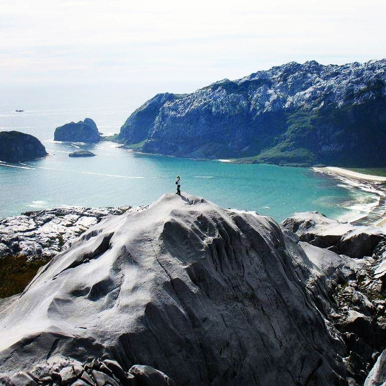 Person on top of a mountain, Madre de Dios island