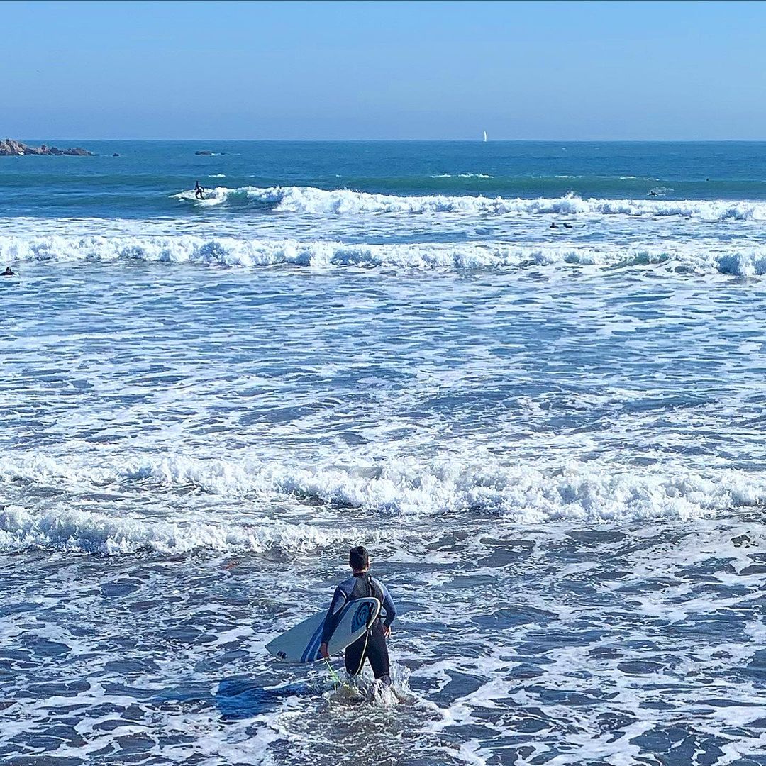 Surfer at La Boca beach, Concón, central coast of Chile