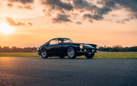 A black car parked on a roadAI-generated content may be incorrect.
