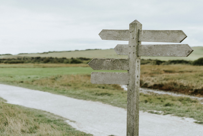 Road sign pointing to different directions