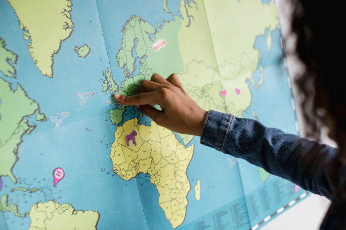 girl pointing at a map