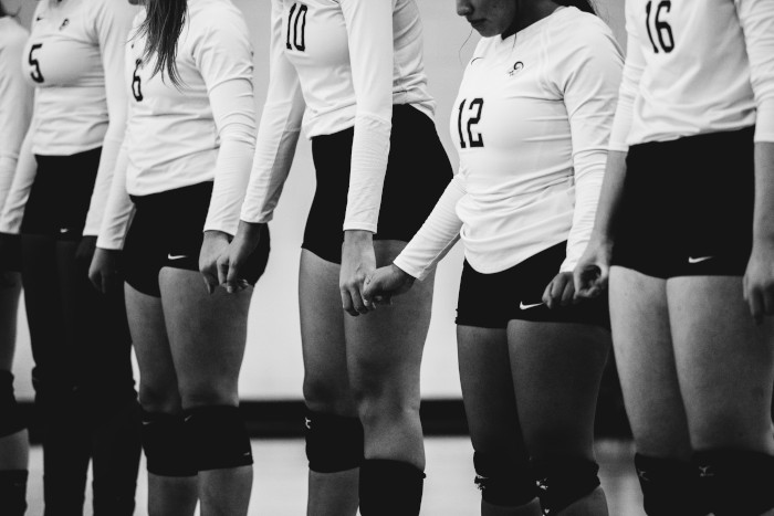 volleyball team holding hands