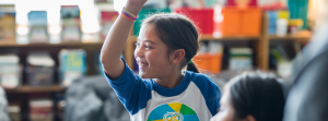 Students with raised hands in classroom