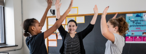 Students high-fiving in the classroom