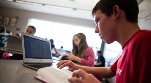 Student working on a computer to complete an assignment