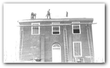 The courthouse being updated in the 1960's. Note the addition of the supports in the front..