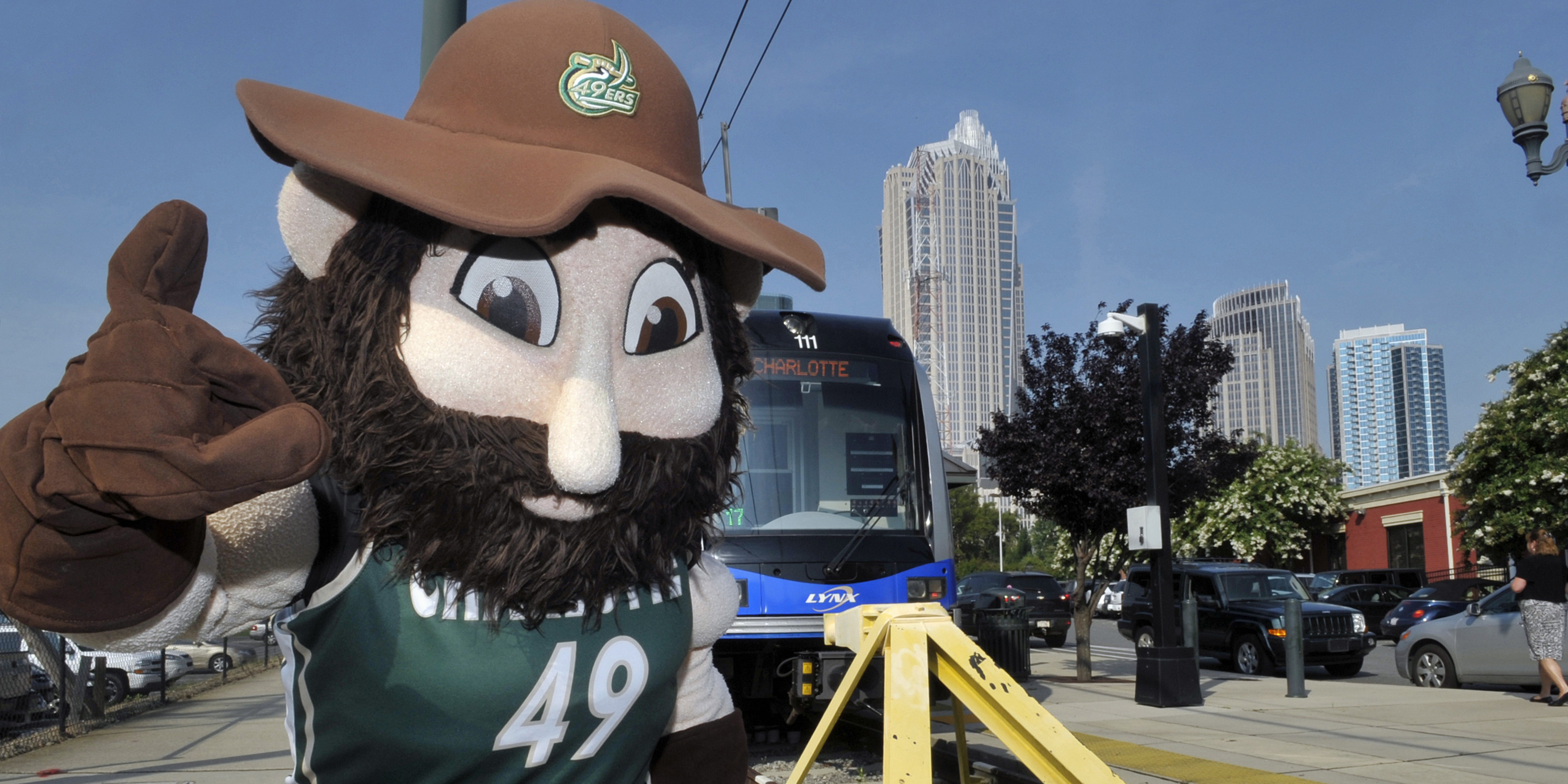 UNC Charlotte mascot, Norm the Miner, celebrates the groundbreaking for the LYNX Blue Line Extension in uptown Charlotte on July 18, 2013.
