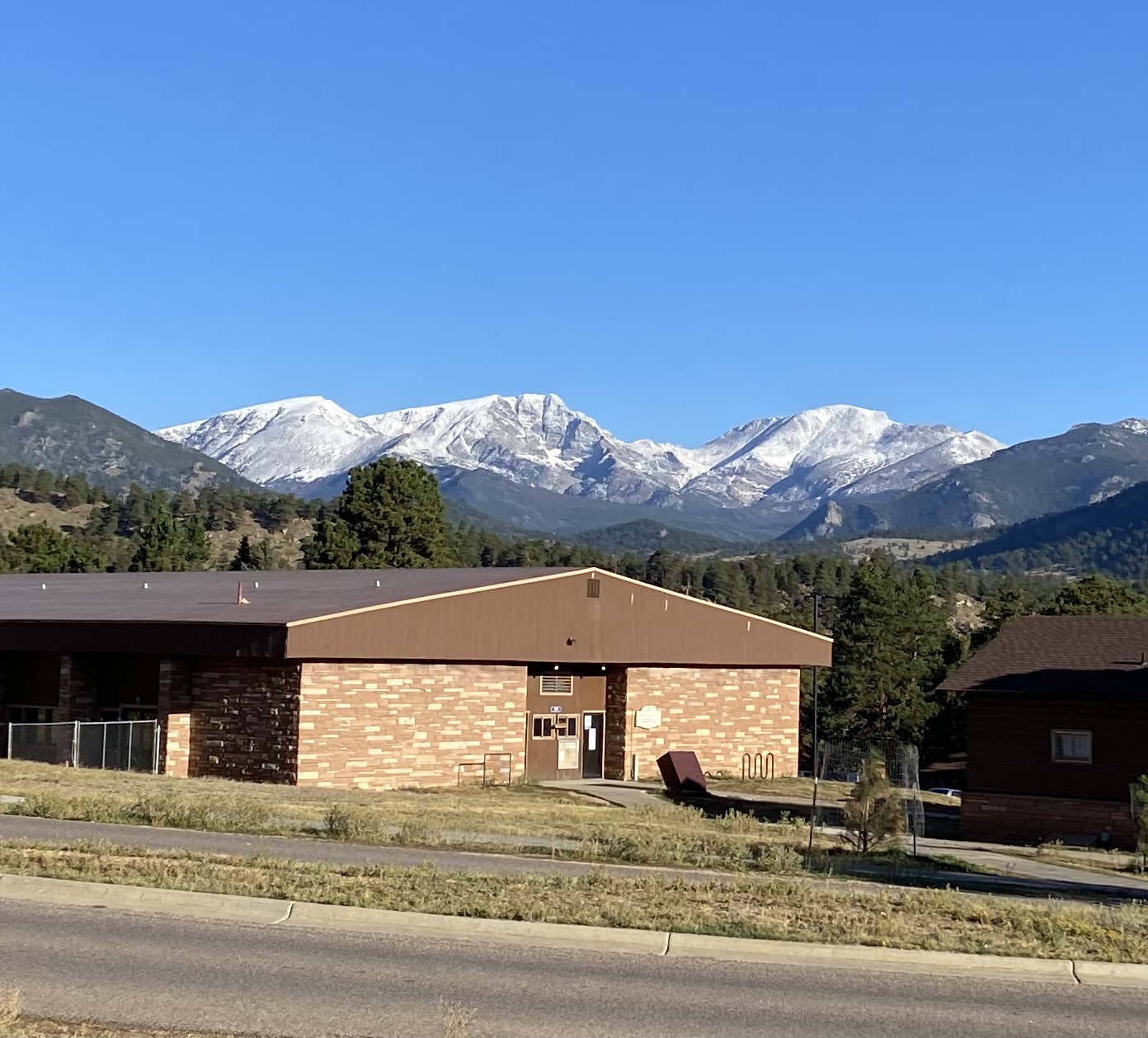 This image shows three, snowy mountain peaks of the Mummy Range, seen from YMCA of the Rockies property. Mt. Ypsilon is the center peak.