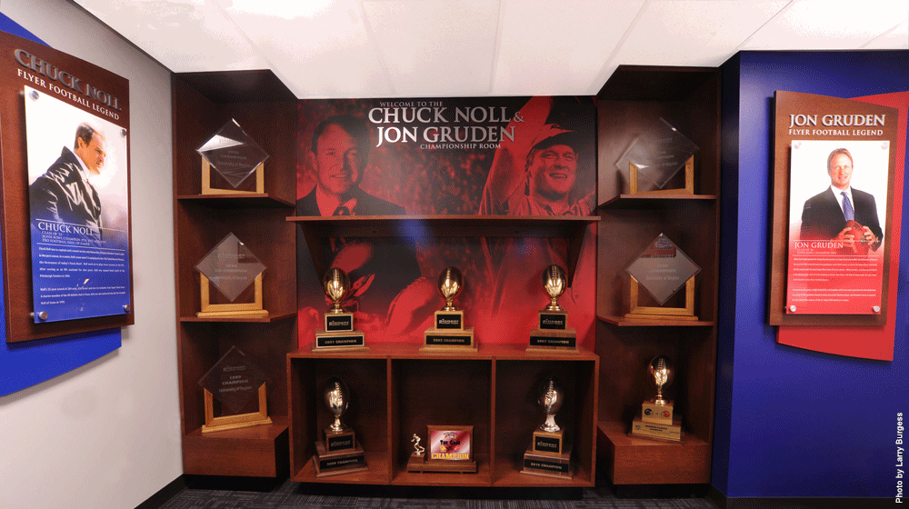 The University of Dayton Athletics Department dedicated The Chuck Noll-Jon Gruden Championship Room in 2013.