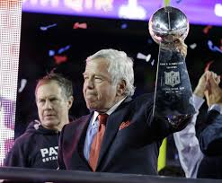New England Patriots owner Robert Kraft receiving Super Bowl trophy, stating "We are all Patriots" during speech.