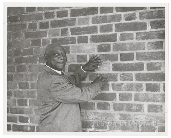 A photograph of George Black at his brickyard in 1956.