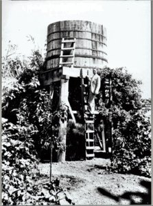 Llewellyn Bixby Sr posing by water tower (1930s)